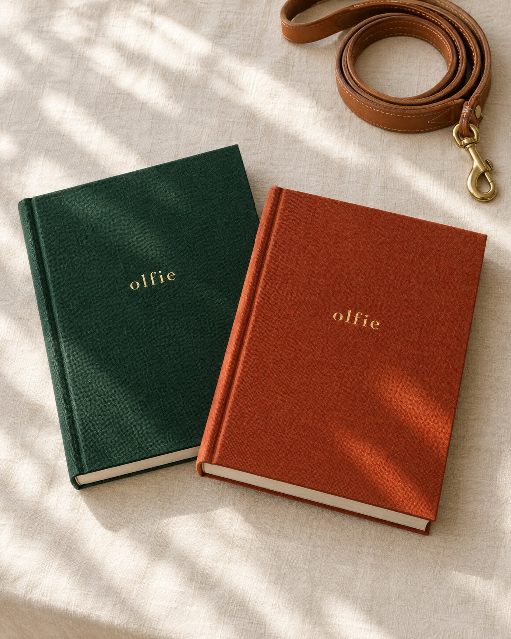 The Olfie Book in forest green and terracotta cloth, side by side