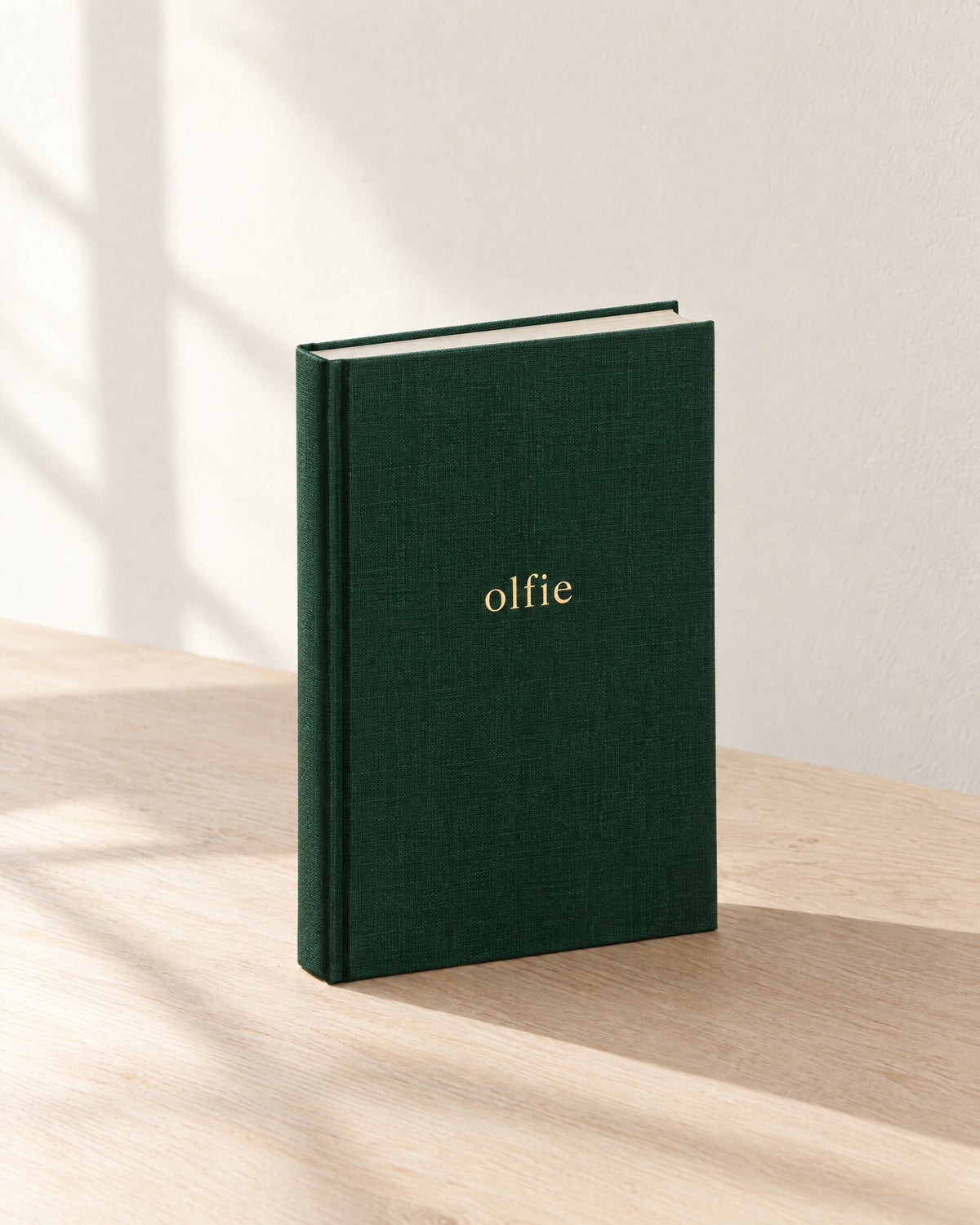 The Olfie Book in forest green cloth with a gold foil wordmark