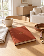 The Olfie Book in terracotta on a kitchen table at home