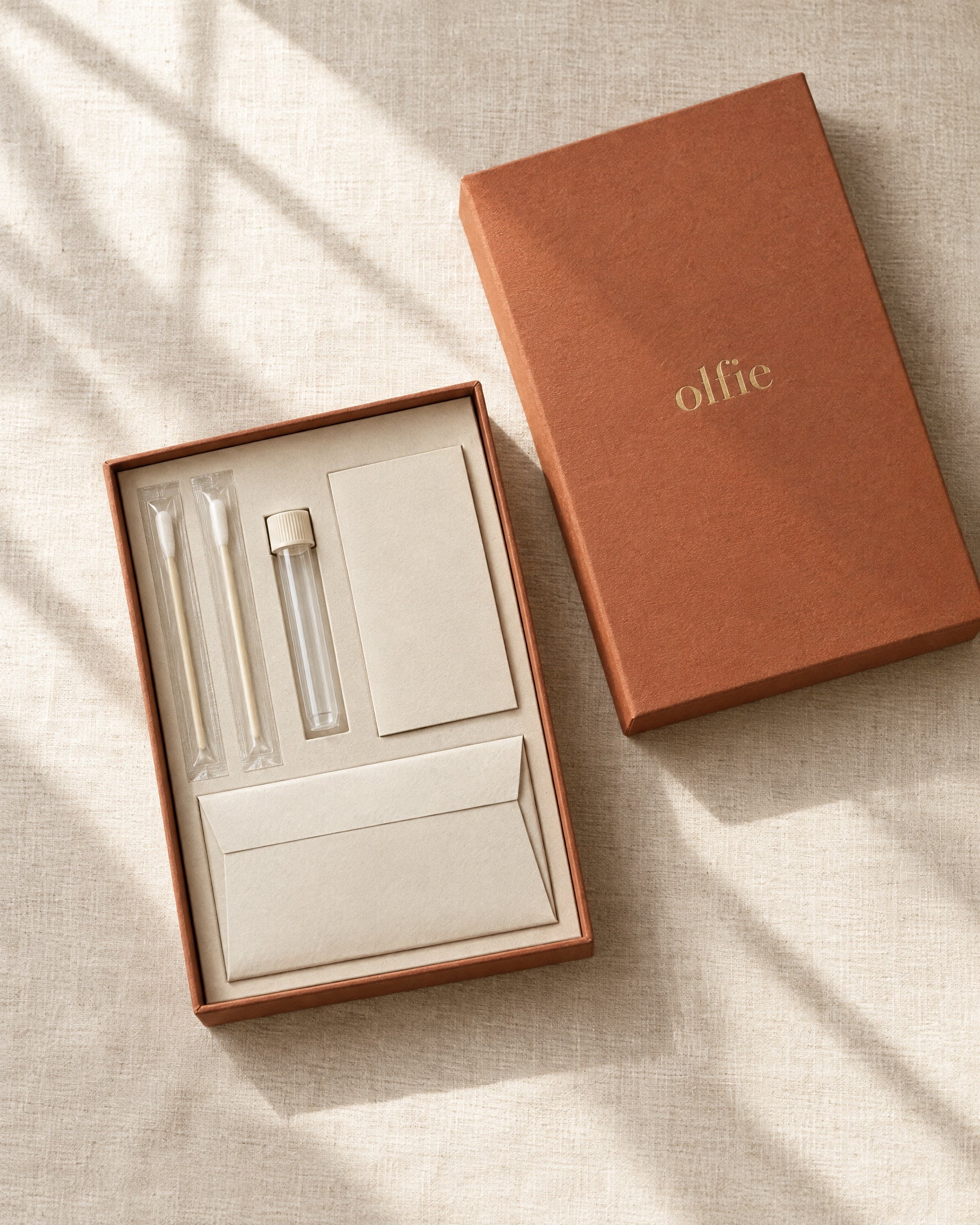 The Olfie Life Test kit: cheek swabs, a sample tube, a registration card and a reply envelope